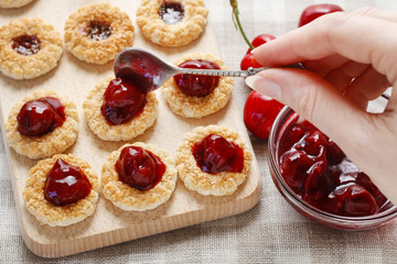 Puff pastry cookies filled with cherry jam