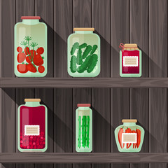 Collection of flat jars of vegetable pickles on the wood background.