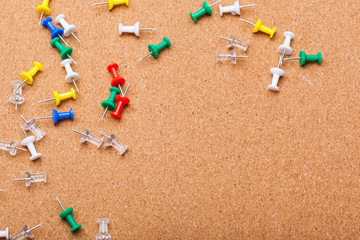 Pins on brown cork board