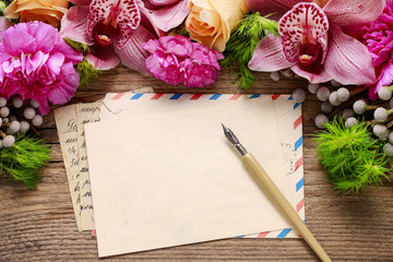 Floral arrangement with orchids, roses and carnations.