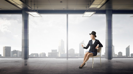 Obraz na płótnie Canvas Businesswoman on chair in office . Mixed media