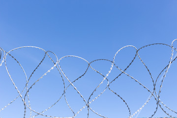 curve barbed wire on blue background