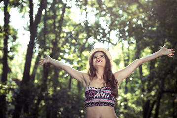 Girl stretching arms in forest