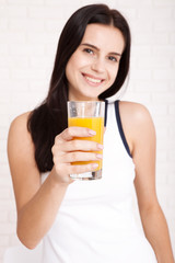 Woman drinking orange juice Beautiful mixed-race Asian, Caucasian model.
