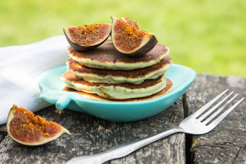making pancakes with figs and honey in the garden on a rustic ta