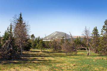 Top of the Iremel mountain by rays of the rising sun. South Ural