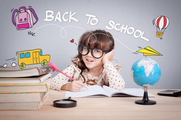 Cute little girl studying at the library and thinking, school concept