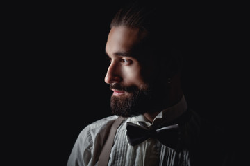 Portrait of handsome man posing for photographer in studio