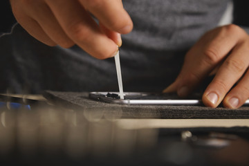 Removing battery glue from opened smartphone to replace and fix it with new one