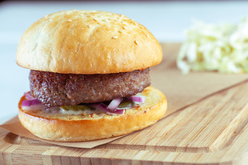 home made burgers on wooden background