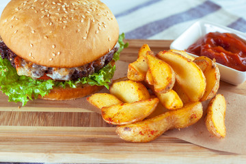 burger and french fries on wooden table