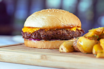 burger and french fries on wooden table