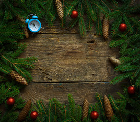Fototapeta na wymiar Christmas tree branches with cones and christmas decorations on