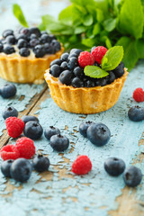 Delicious cupcake with fresh blueberry and raspberry