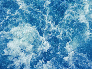 cruise ship trails on water surface making white foam