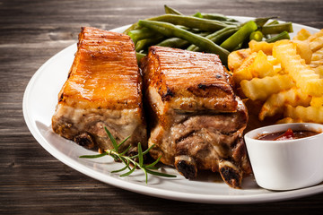Grilled ribs, boiled potatoes and vegetables 