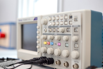 oscilloscope lab item on the table, a photo with a small depth of field, buttons and switches