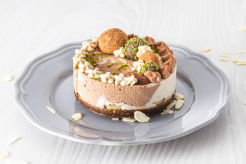 Raw vegan cake with lime, banana and chocolate, decorated with lime zest and chocolate balls