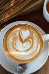 latte art coffee on wood background