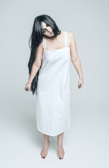 Mystical ghost woman in white long shirt