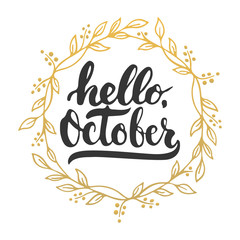 Fototapeta premium Hand drawn typography lettering phrase Hello, October isolated on the white background with golden wreath. Fun brush ink calligraphy inscription for greeting and invitation card or print design