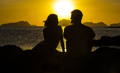 Silhouettes loving couple at sunset on the Philippine Islands