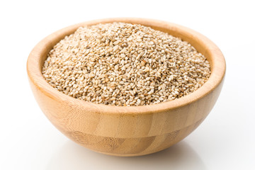 wooden bowl full of sesame seeds, isolated