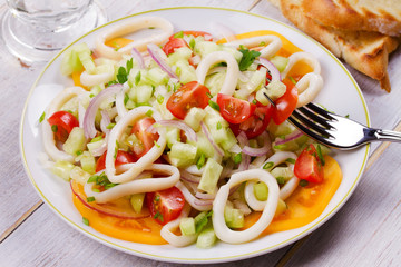 Squid, tomato, onion and greens salad