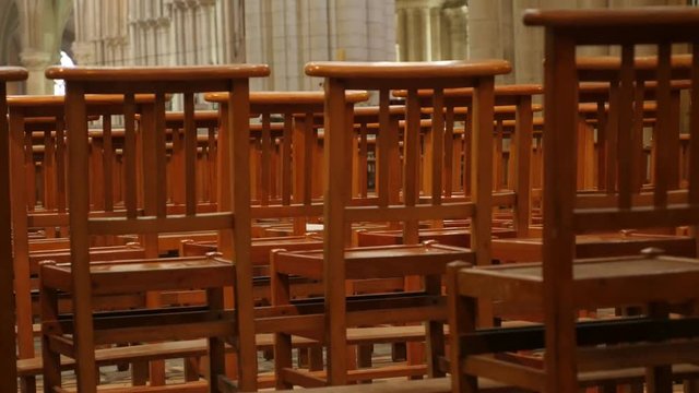 Behind empty cathedral wooden chairs in a row worship building 4K 3840X2160 30fps UltraHD footage - Row of wooden seats in Christian church 4K 2160p UHD video 