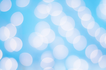 Bright blue sparkly abstract background of Christmas holiday bokeh lights with copy space.