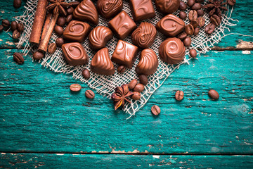 Delicious chocolate candies on wooden background