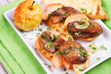 Chicken liver, apple and onion sandwiches on white plate