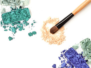 Crushed eyeshadow with brush isolated on white