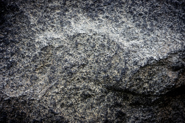 Stone background, rock wall backdrop with rough texture. Abstract, grungy and textured surface of stone material. Nature detail of rocks.