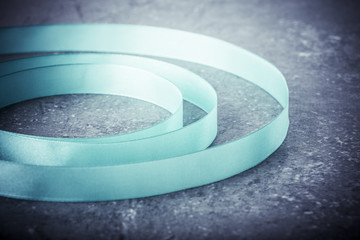 Silk ribbon still life with creative pattern. Abstract background with curve shape. Concept of creativity, decoration, art and craft.