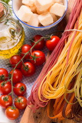  Vegetable color Pasta, oil,tomatoes,cheese on wooden table. italian food