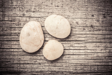 Stones on wooden background, concept of harmony and tranquility. Decoration with stone pebbles as natural design backdrop with copy space.