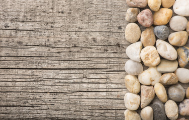 Stones on wooden background, concept of harmony and tranquility. Decoration with stone pebbles as natural design backdrop with copy space.