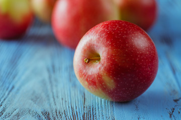Organic apples on wooden table.