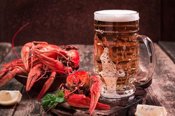boiled crawfish and beer on a wooden background