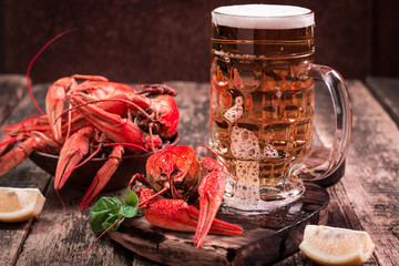 boiled crawfish and beer on a wooden background