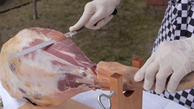 A front leg of Serrano ham mapped on a wooden stand with chef
