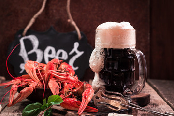 boiled crawfish and beer on a wooden background
