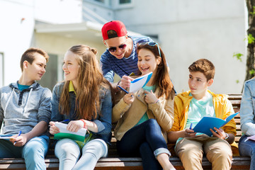 group of students with notebooks at school yard