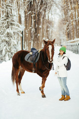 Obraz premium beautiful girl and horse in winter