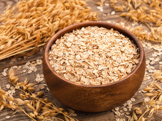oat flakes in a bowl on the old board