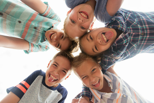 group of happy children showing tongue in circle