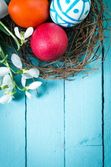 Easter concept with colorful eggs on wooden background
