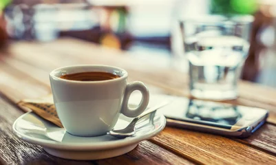 Foto auf Acrylglas Coffee. Coffee break business. Cup of coffee mobile phone on table on restaurant coffee house terrace. © weyo