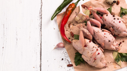Fresh organic quails on vintage wooden table, healthy food